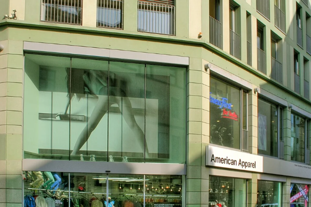American Apparel storefront with Helvetica Bold wordmark in black on white