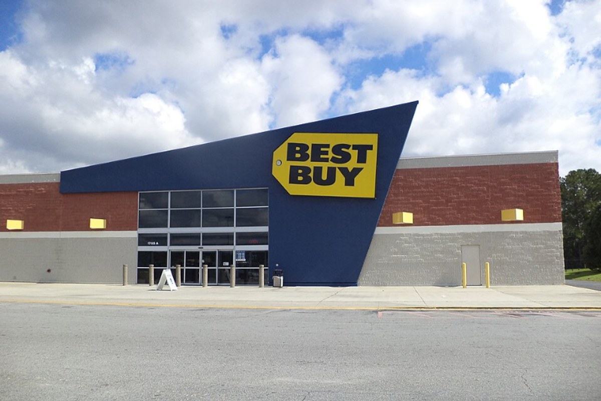 Best Buy logo showing Futura Bold wordmark alongside the yellow price tag icon
