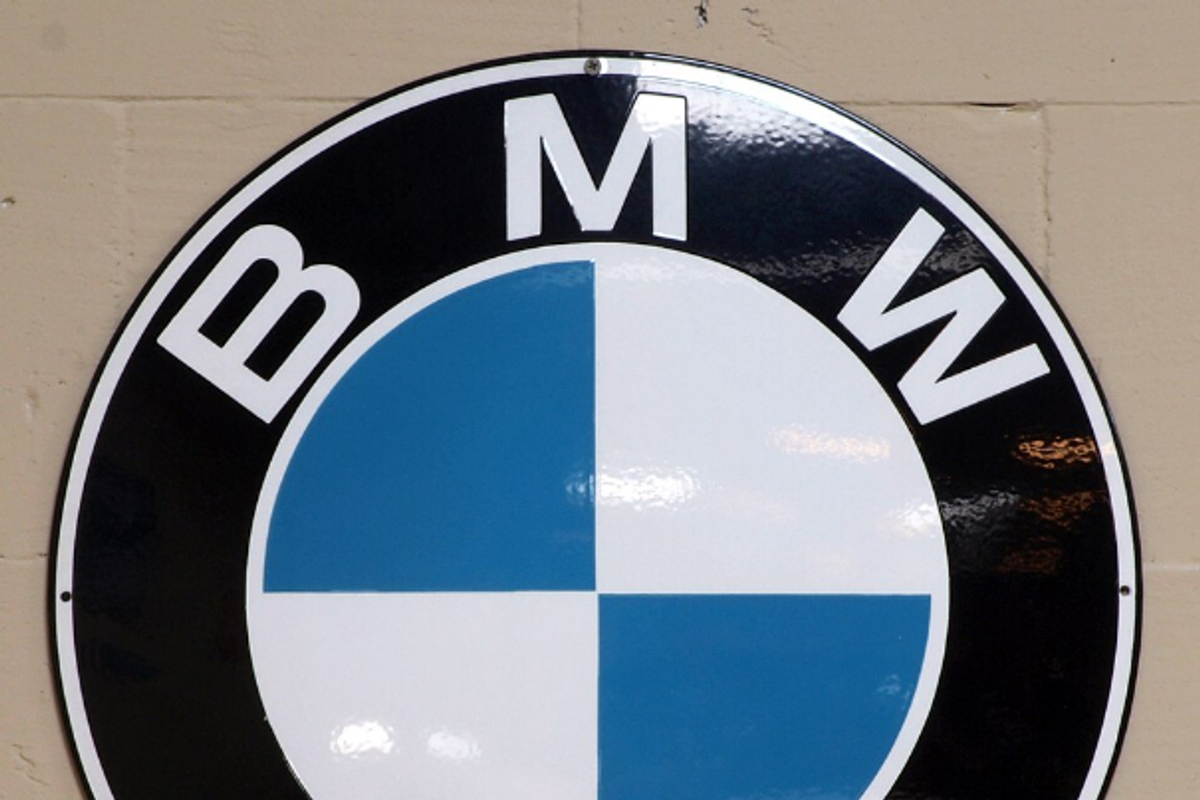 BMW roundel logo with Helvetica Bold wordmark lettering around the perimeter