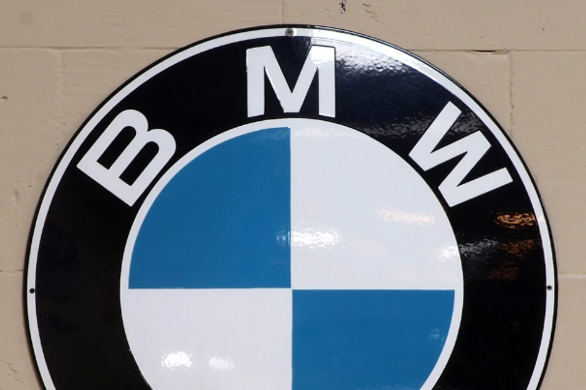 BMW roundel logo with Helvetica Bold wordmark lettering around the perimeter