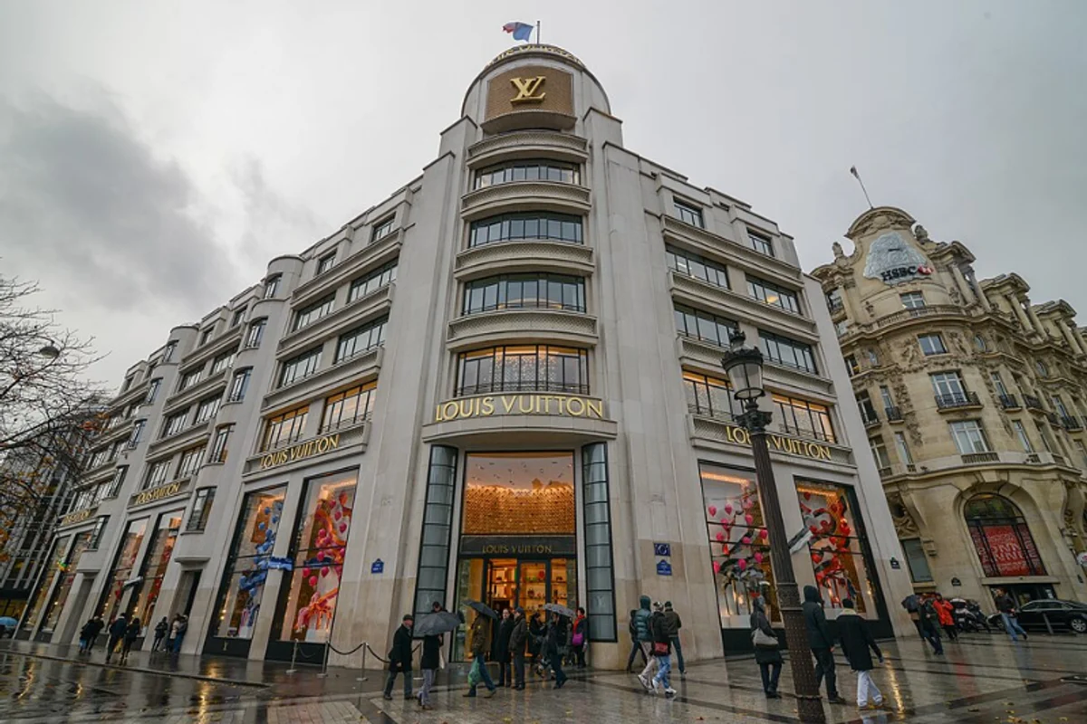 Louis Vuitton storefront with Futura Medium wordmark on marble facade