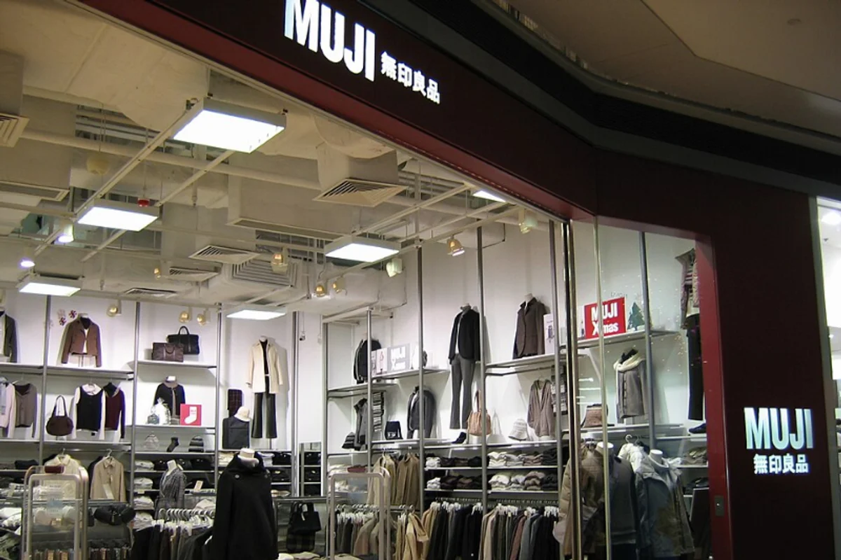 Muji store interior showing minimal signage with Helvetica Neue typography