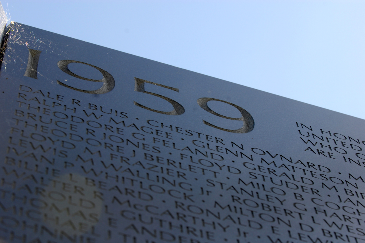 Names of fallen service members carved in Optima typeface on the black granite wall of the Vietnam Veterans Memorial